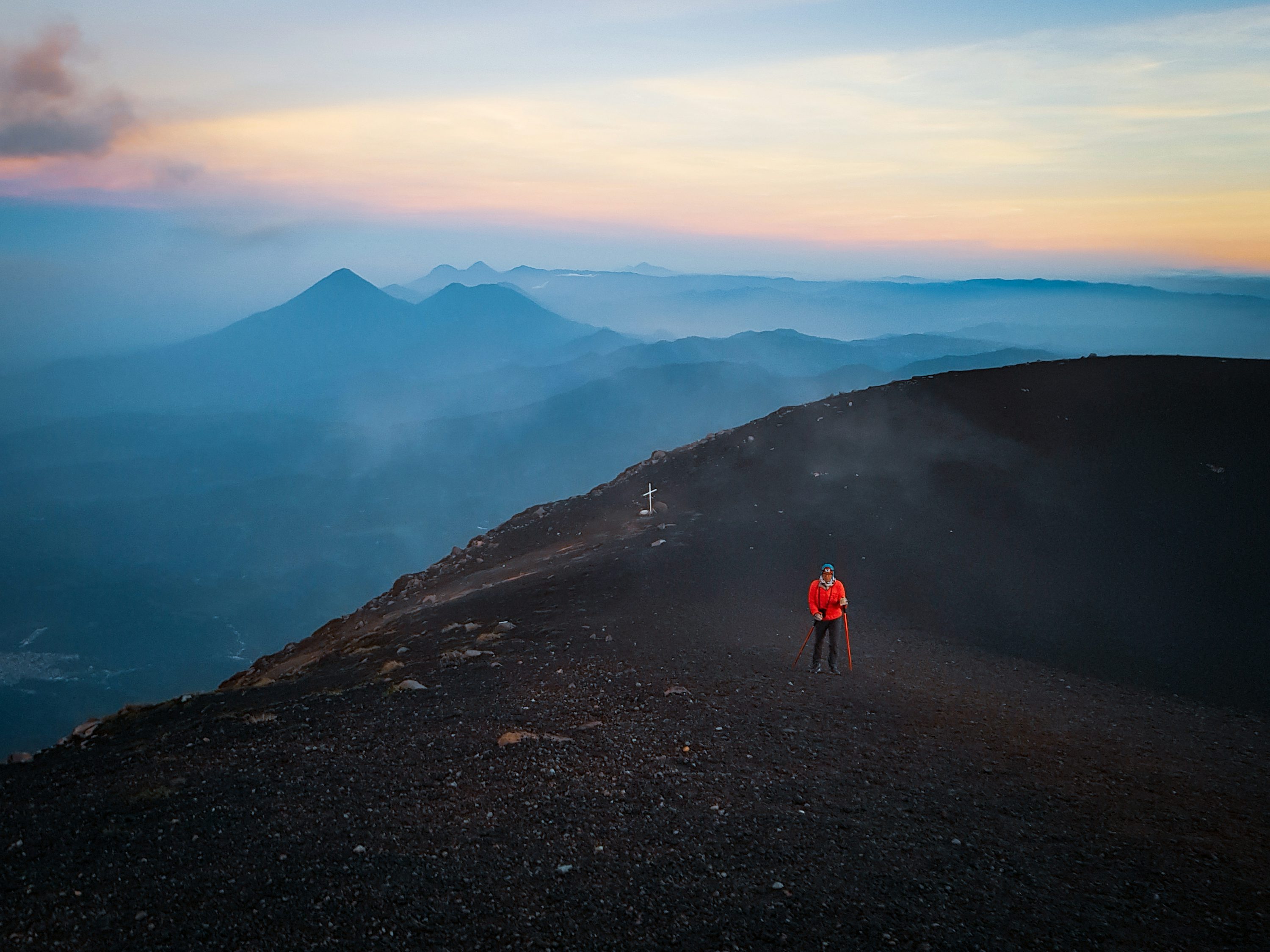 Hiker standing on a volcanic ridge in daylight on the Acatenango trail near Antigua, Guatemala