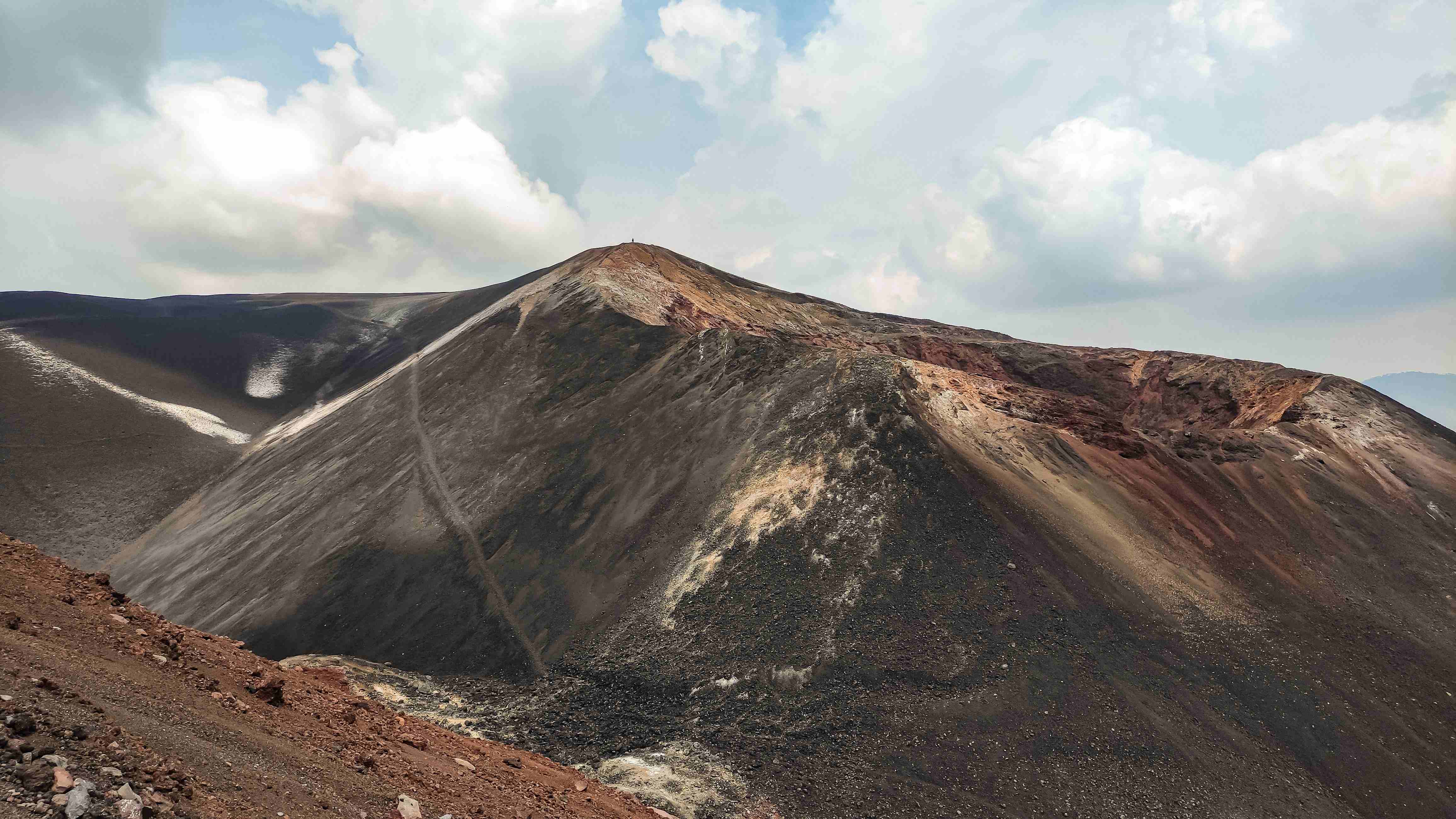Boarding down the black volcanic ash slope of Cerro Negro volcano near León, Nicaragua