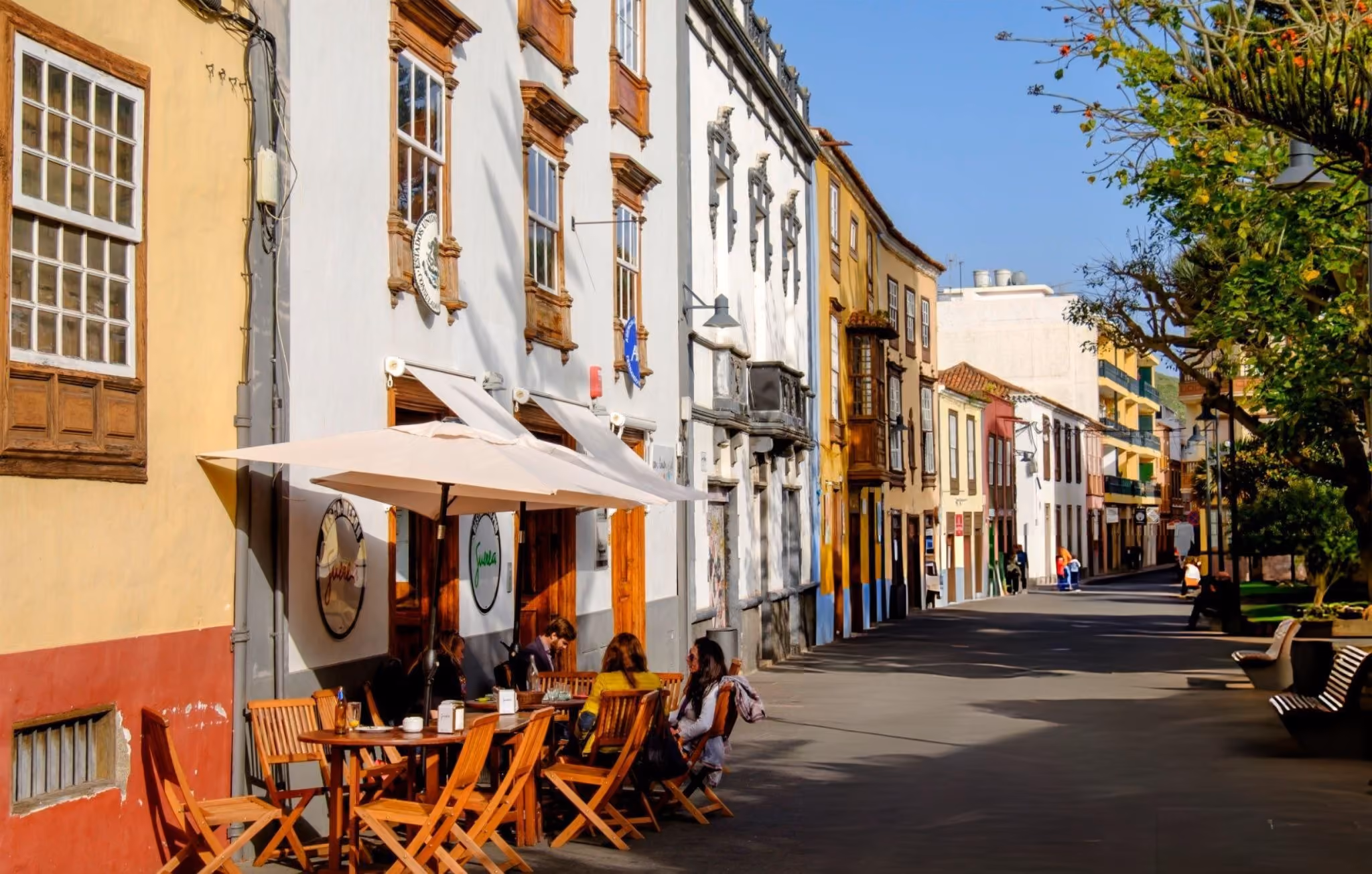 Colorful colonial street with outdoor café seating in La Laguna, Tenerife.