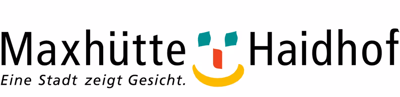 Logo von Maxhütte-Haidhof mit stilisiertem Gesicht und Schriftzug Eine Stadt zeigt Gesicht.