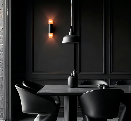 Modern dining area with black chairs, a black table, black pendant light, and a warm wall lamp on dark paneled walls.