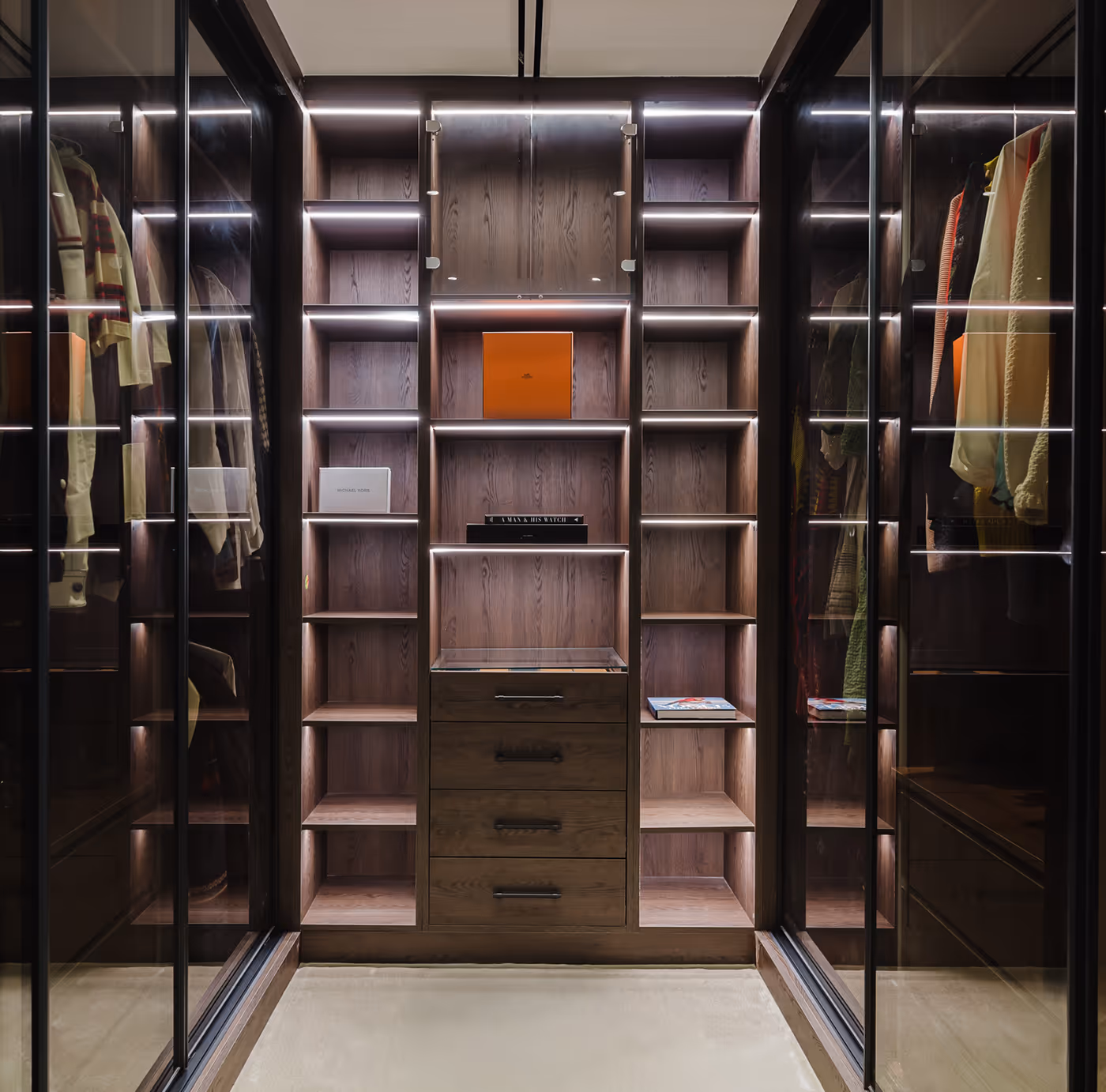 Modern walk-in closet with illuminated wooden shelves and glass-door wardrobes on both sides.