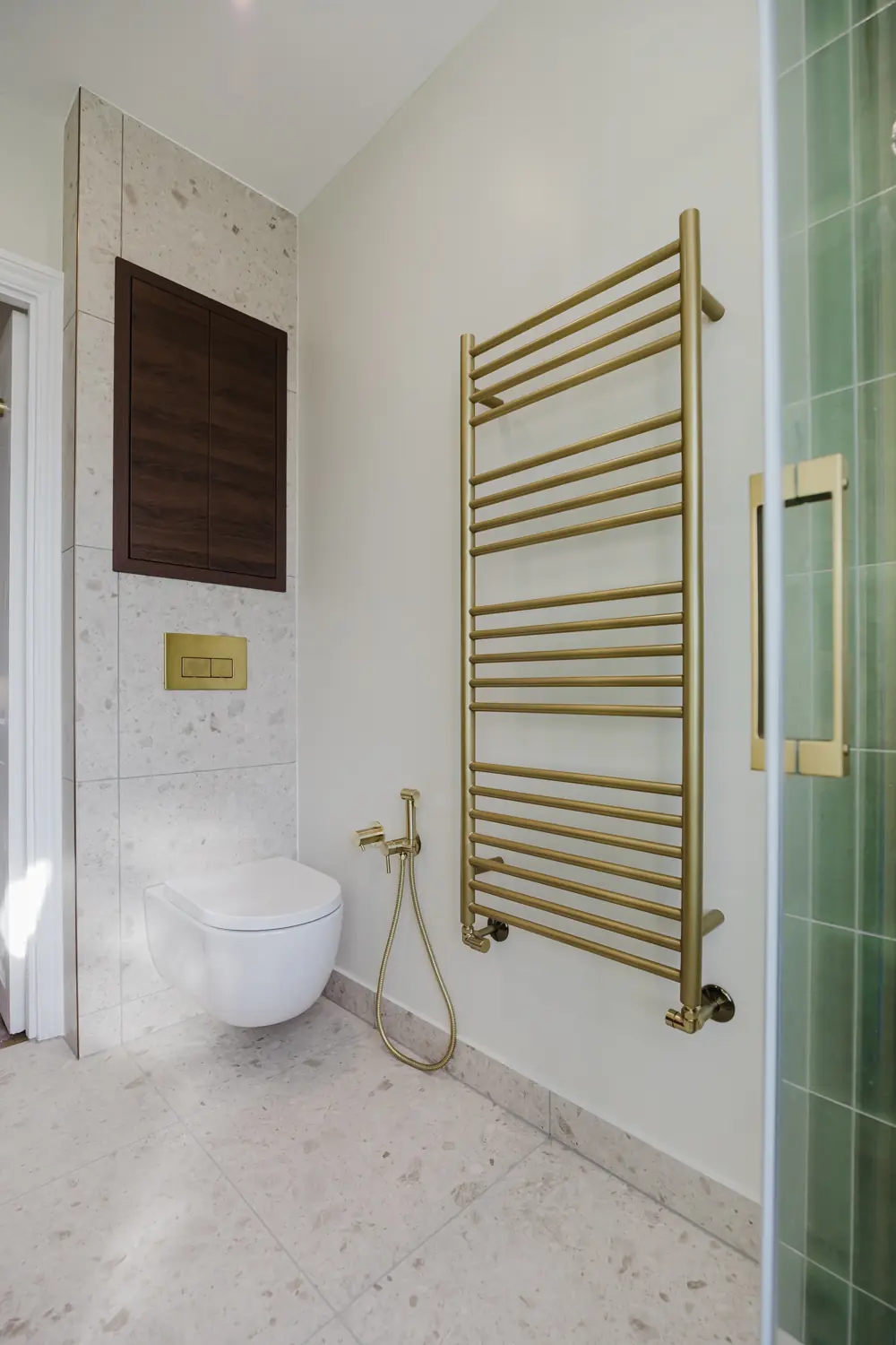 Completed bathroom with wall-hung WC, concealed storage and towel radiator