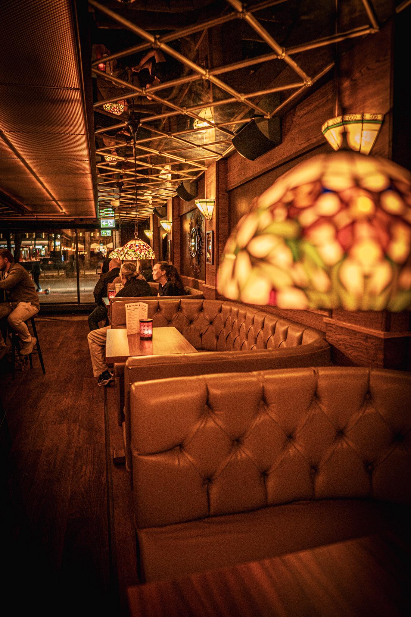 Cosy pub interior at Red Rabbit in Oslo city centre, warm bokeh lights and velvet seating