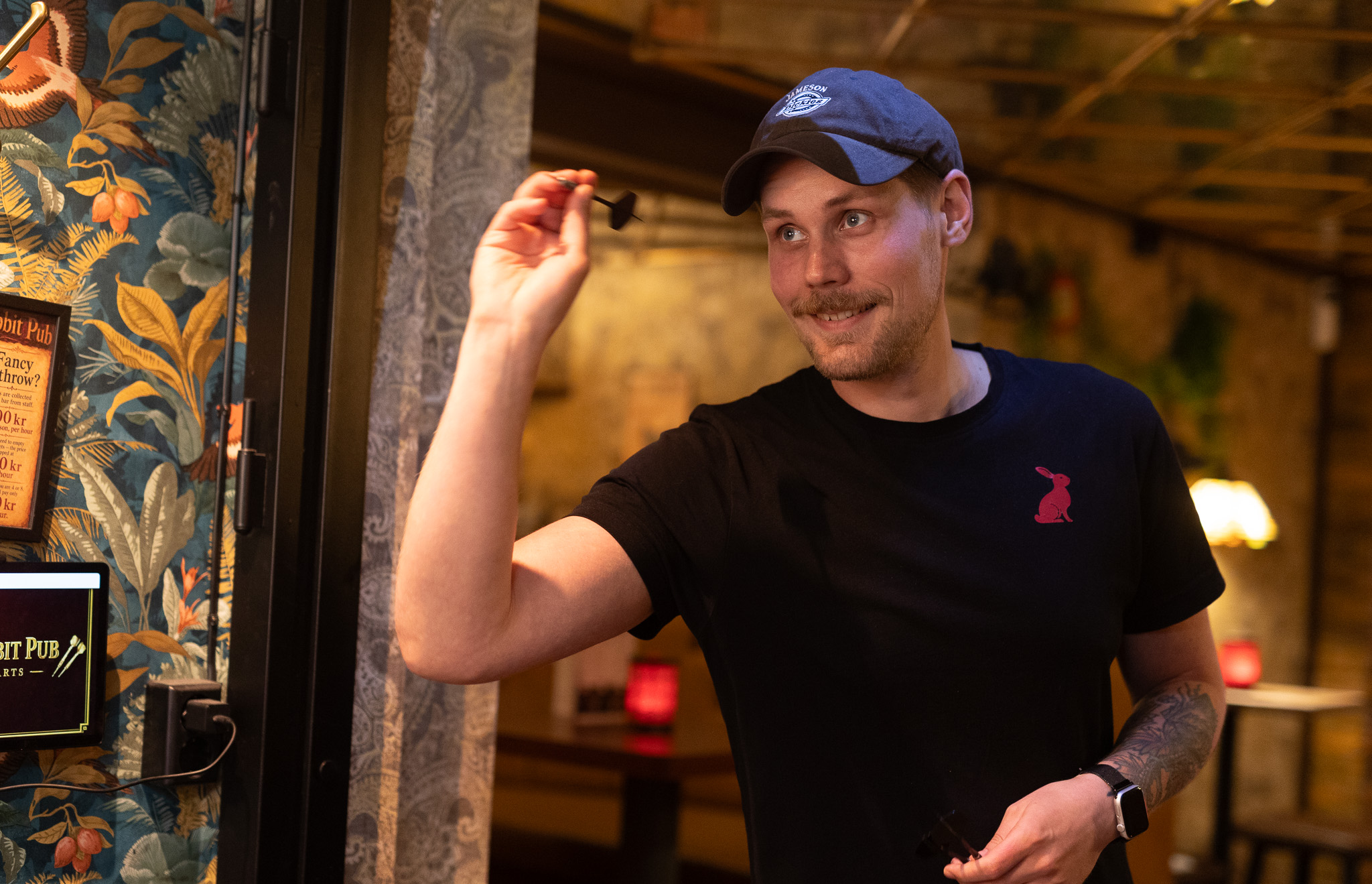 A guest throwing a dart near the entrance at Red Rabbit Pub Oslo