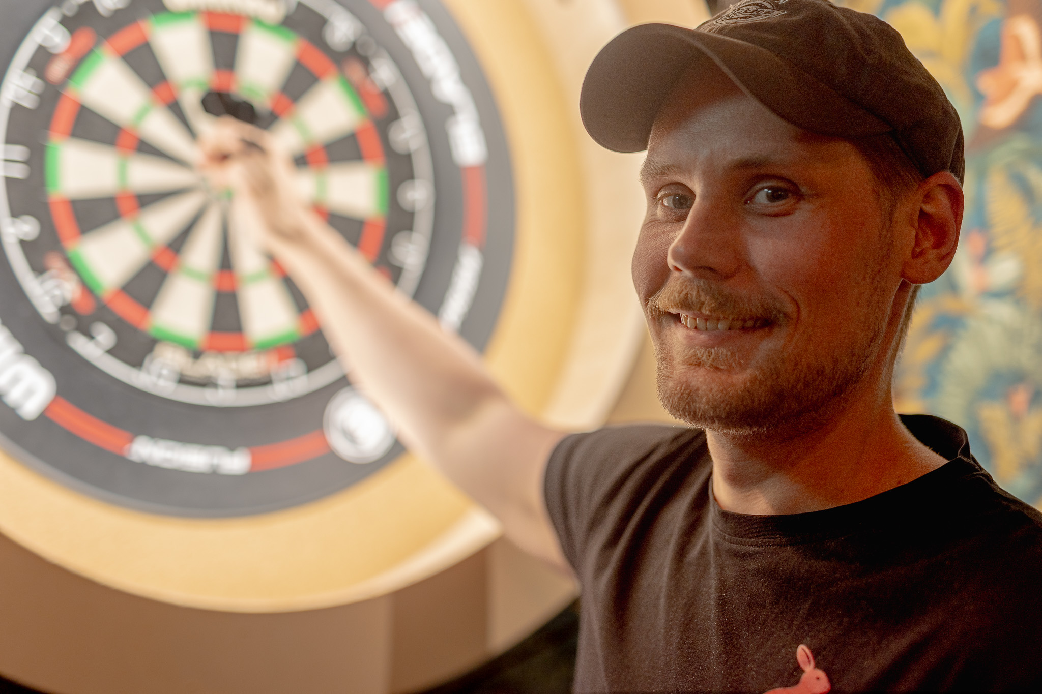 A guest lining up a dart shot at Red Rabbit Pub Oslo