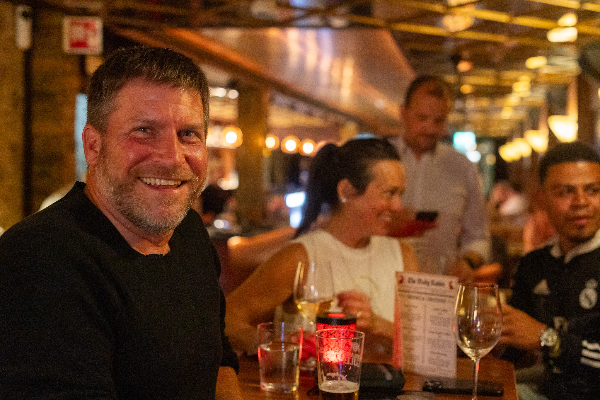 A guest smiling at a table at Red Rabbit Pub Oslo