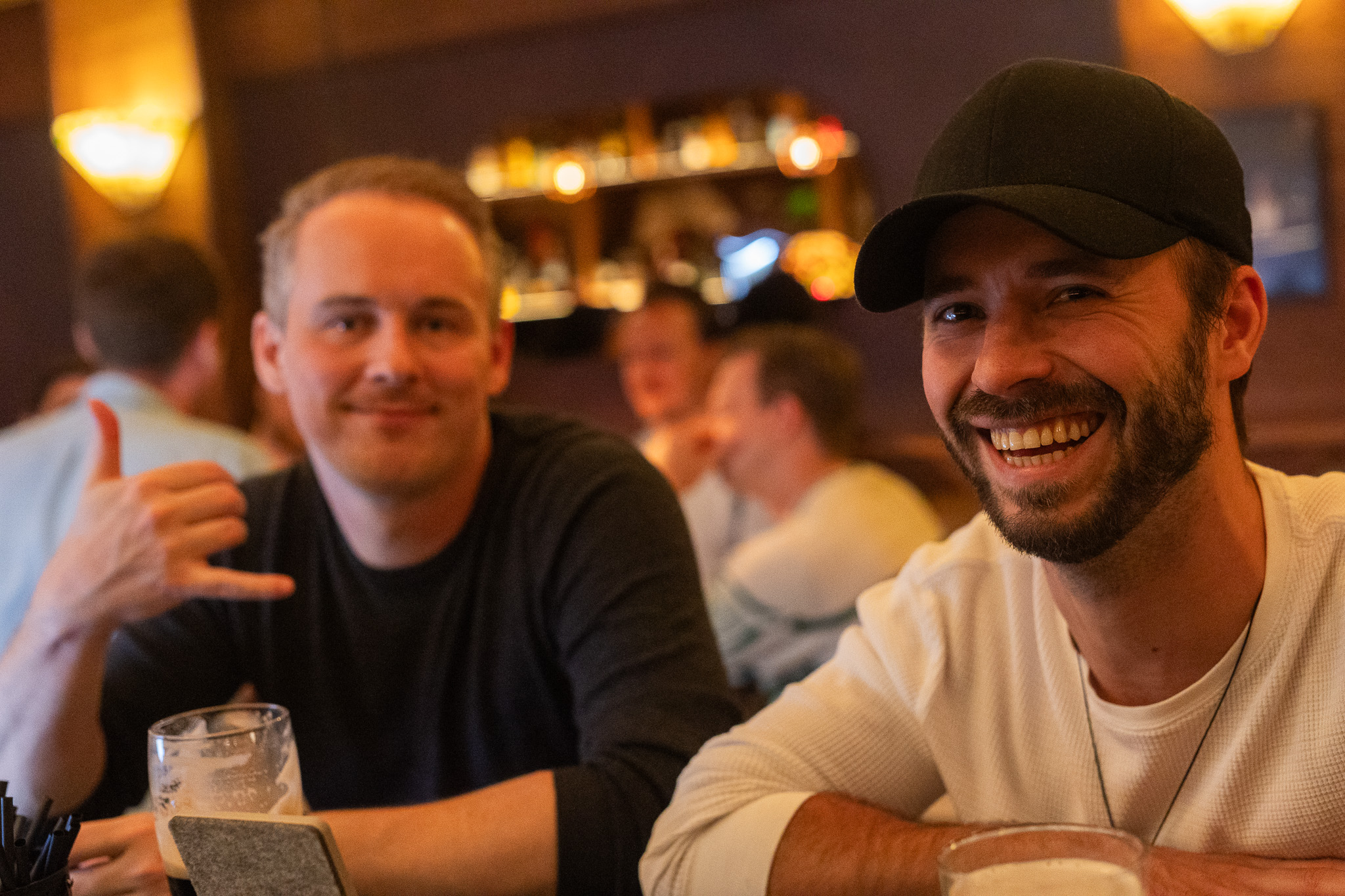 Two friends smiling at the bar at Red Rabbit Pub Oslo