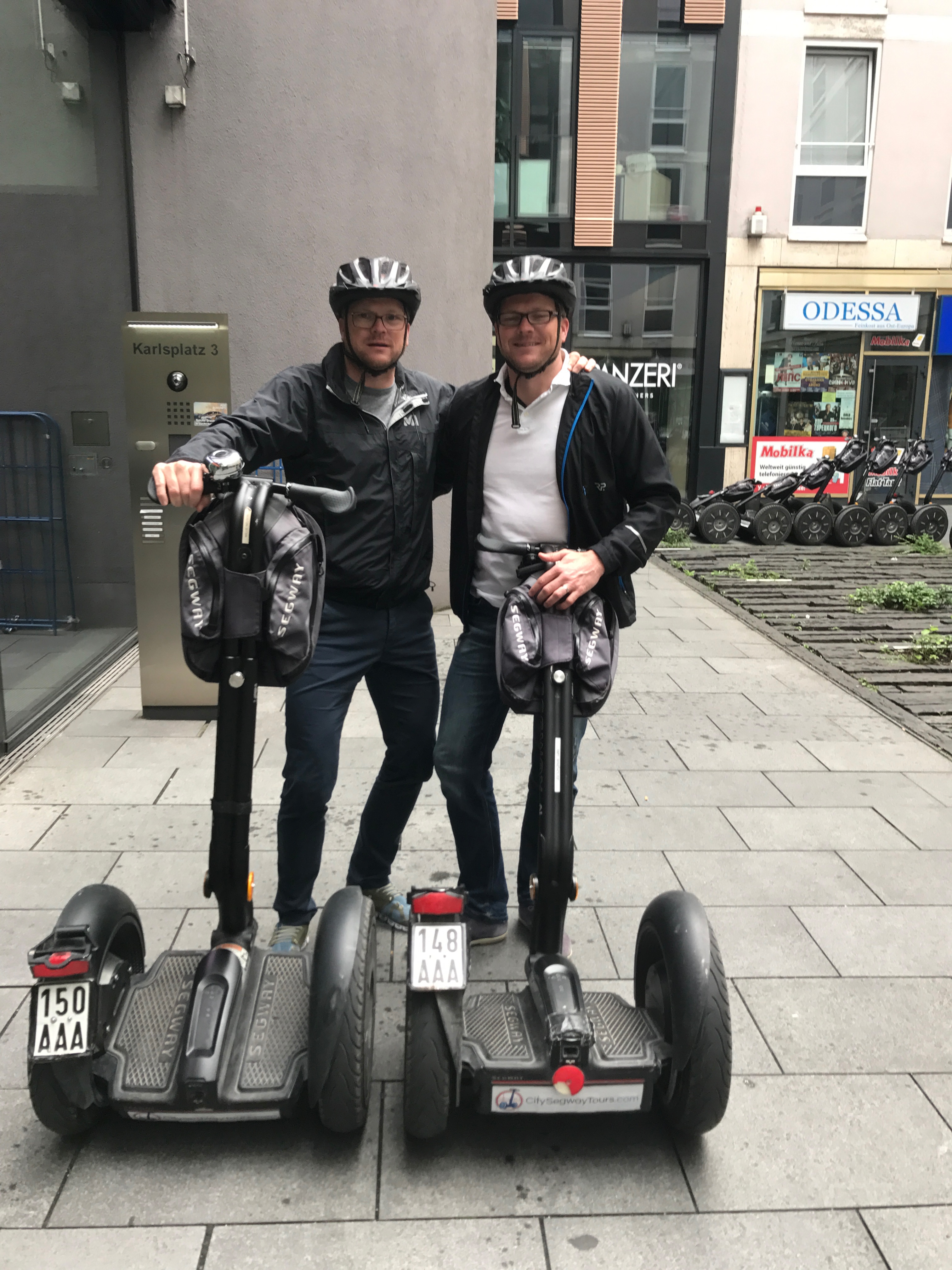 Zwei der Steuerberater stehen hinter zwei Segways