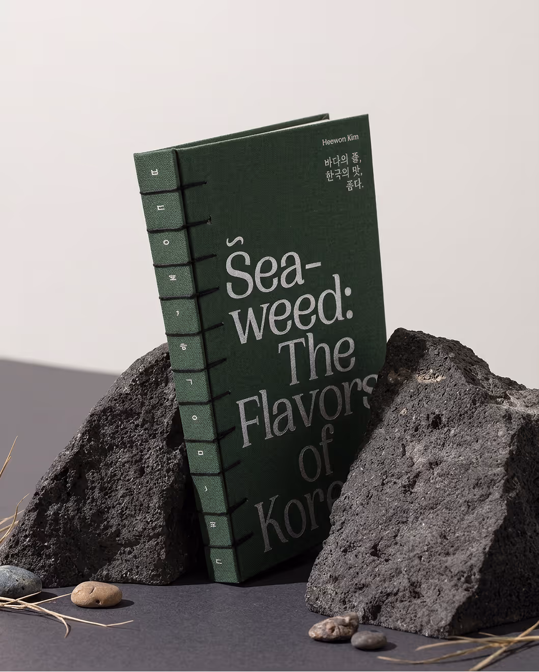 A cookbook placed between rocks.