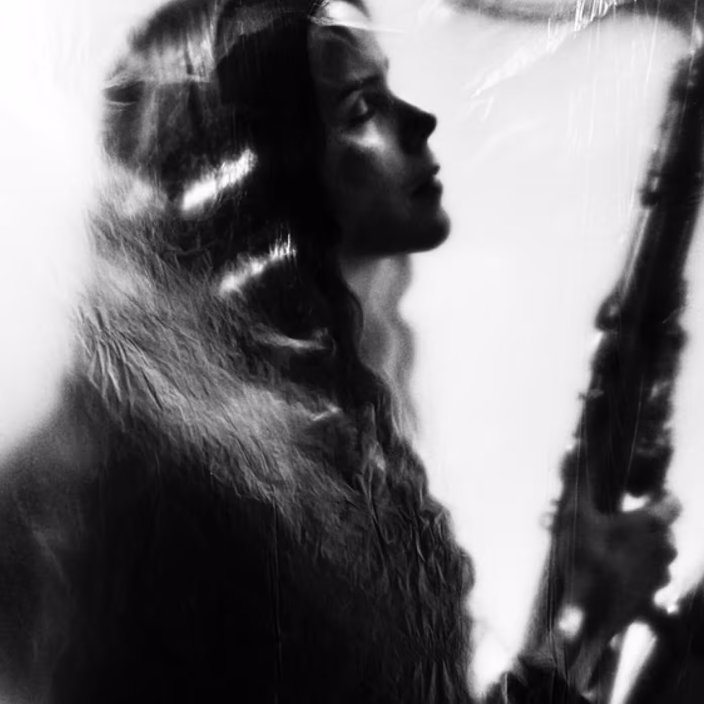 Black and white photo of recording artist, Mette Henriette, holding a saxophone