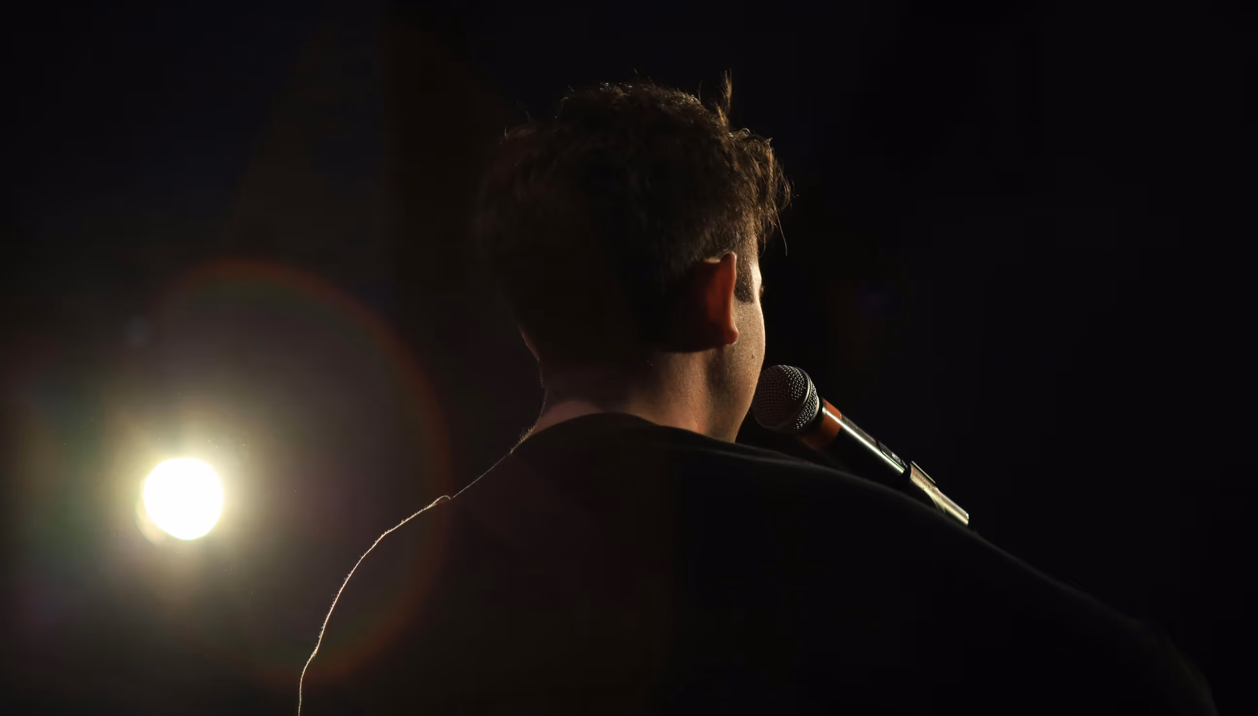 Close up of back of the head of a person speaking