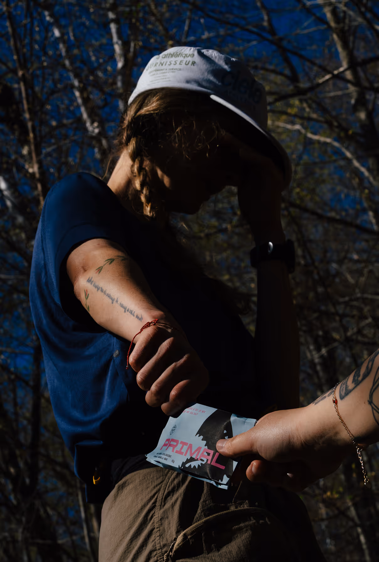 Granola bar being handed off, full body. Photo credit Felix Burke.