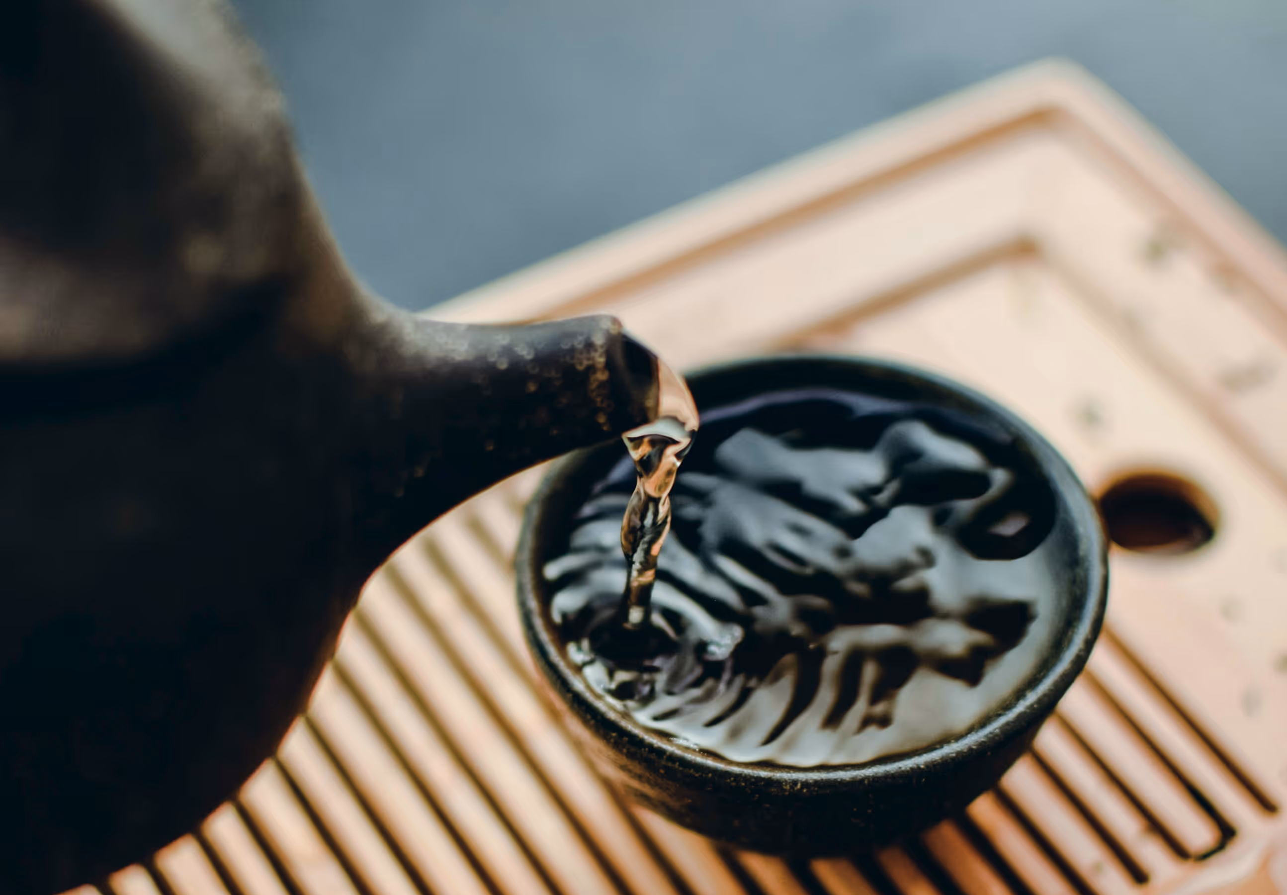 Image of tea being poured in a cup