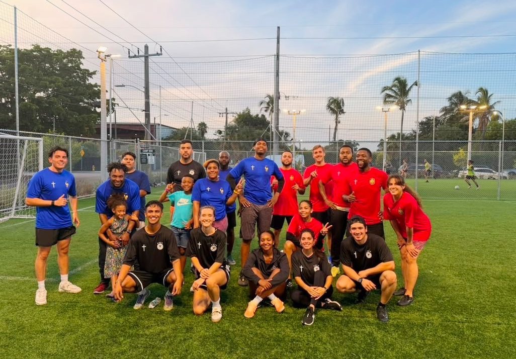 A Fitness Crew on a soccer field at sunset
