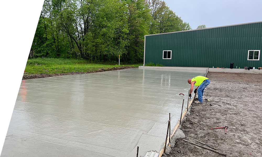 Heavy equipment laying fresh asphalt during a paving project with smooth surface finish