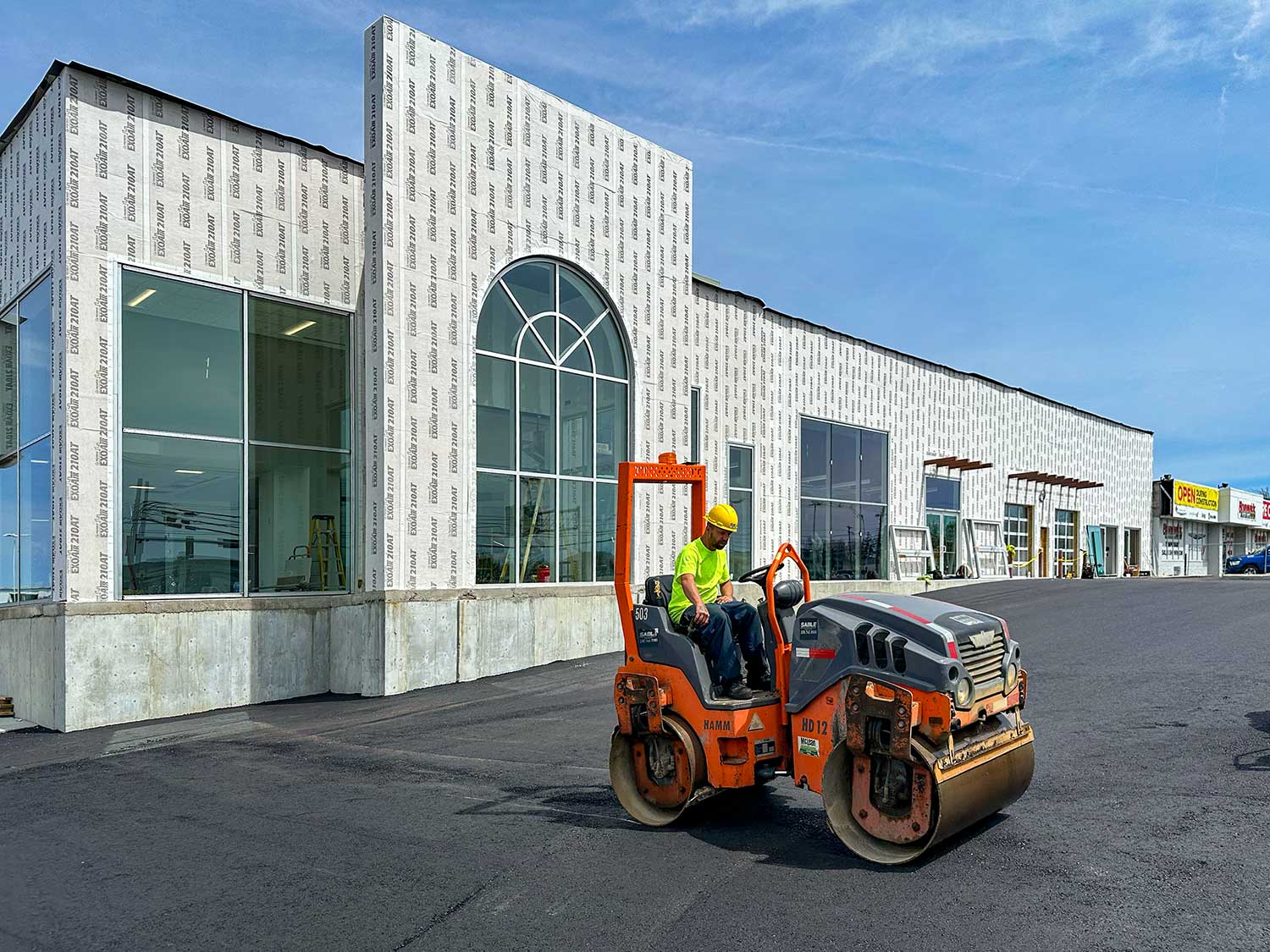 Sable Asphalt crew rolling in a new, smooth parking lot surface.
