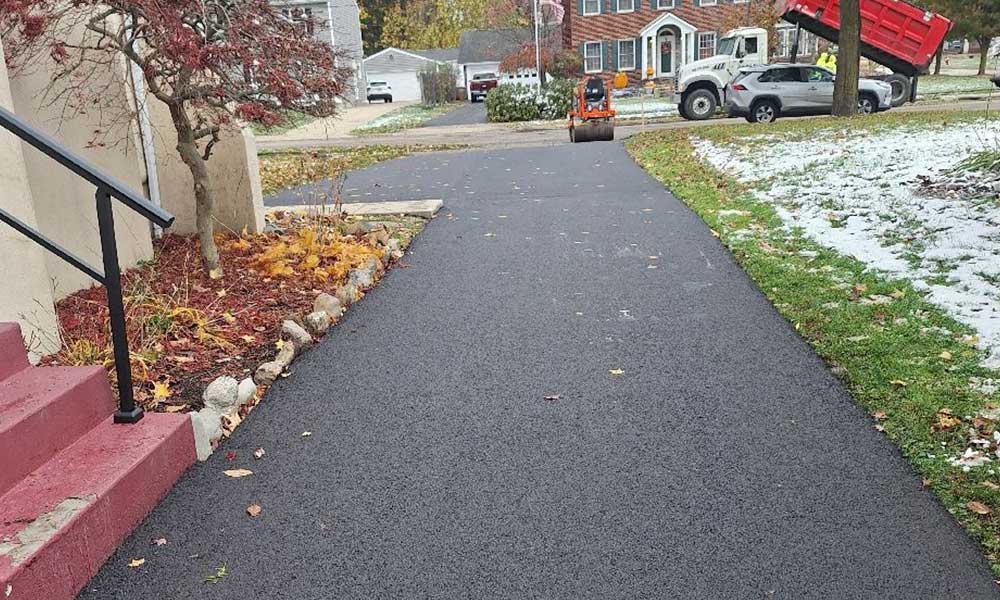 Wide asphalt driveway installation designed for long-term residential performance