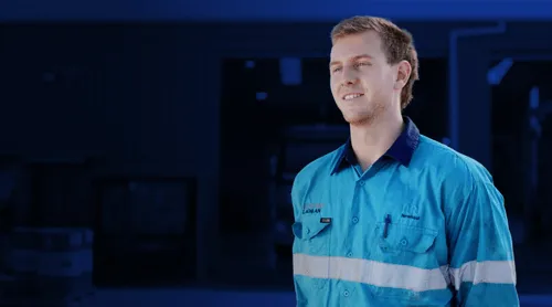 Young man in Kickstart trainee clothes smiling