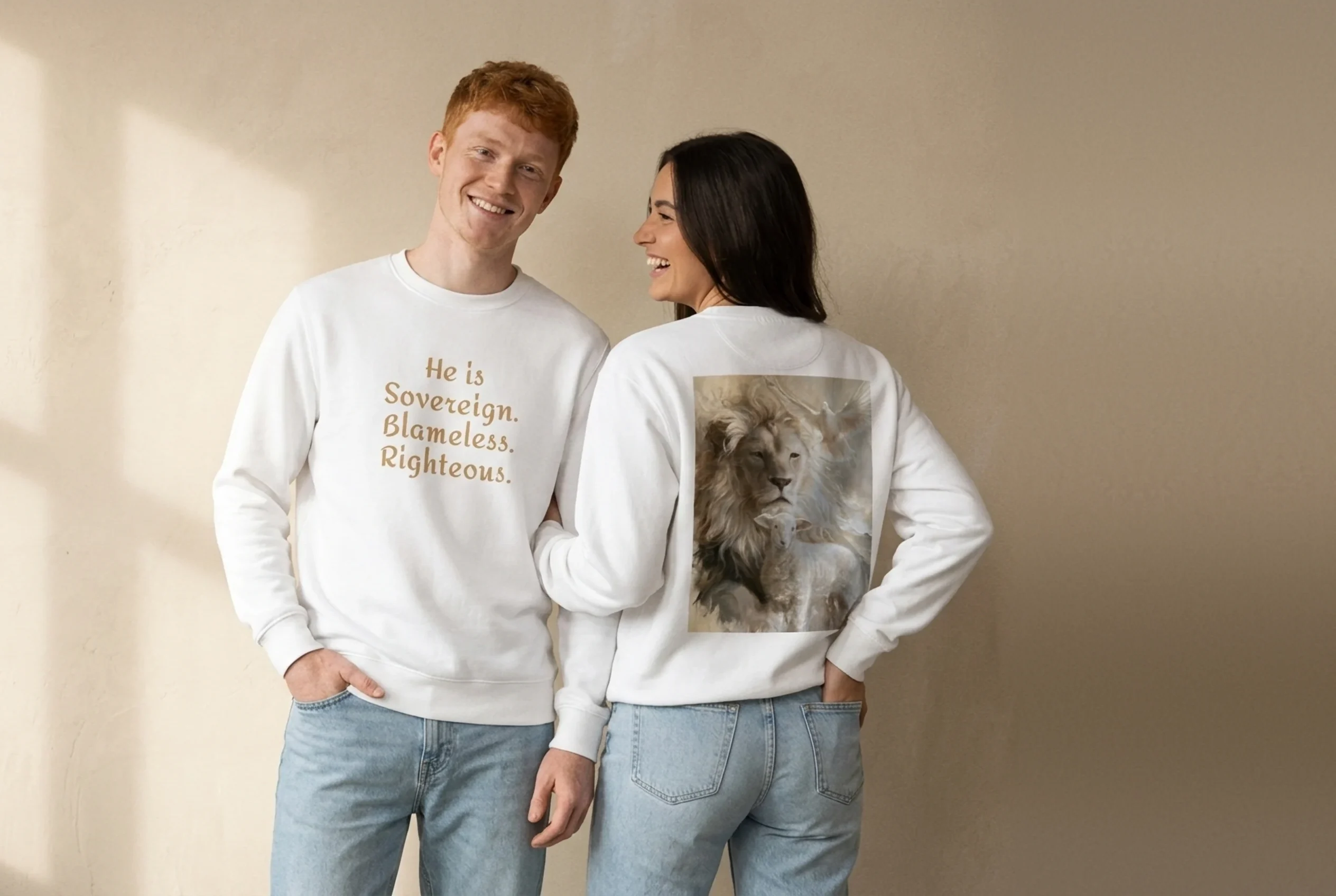 Two friends laughing in white Trinity Sweatshirts by NRB Art: front with “He is Sovereign. Blameless. Righteous.” text, back with lion, lamb and dove artwork