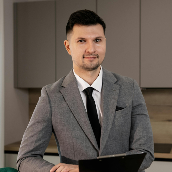 Handsome real estate agent holding a clipboard