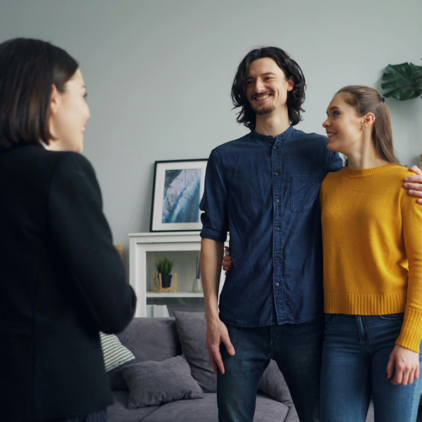 A happy couple talking to their real estate agent