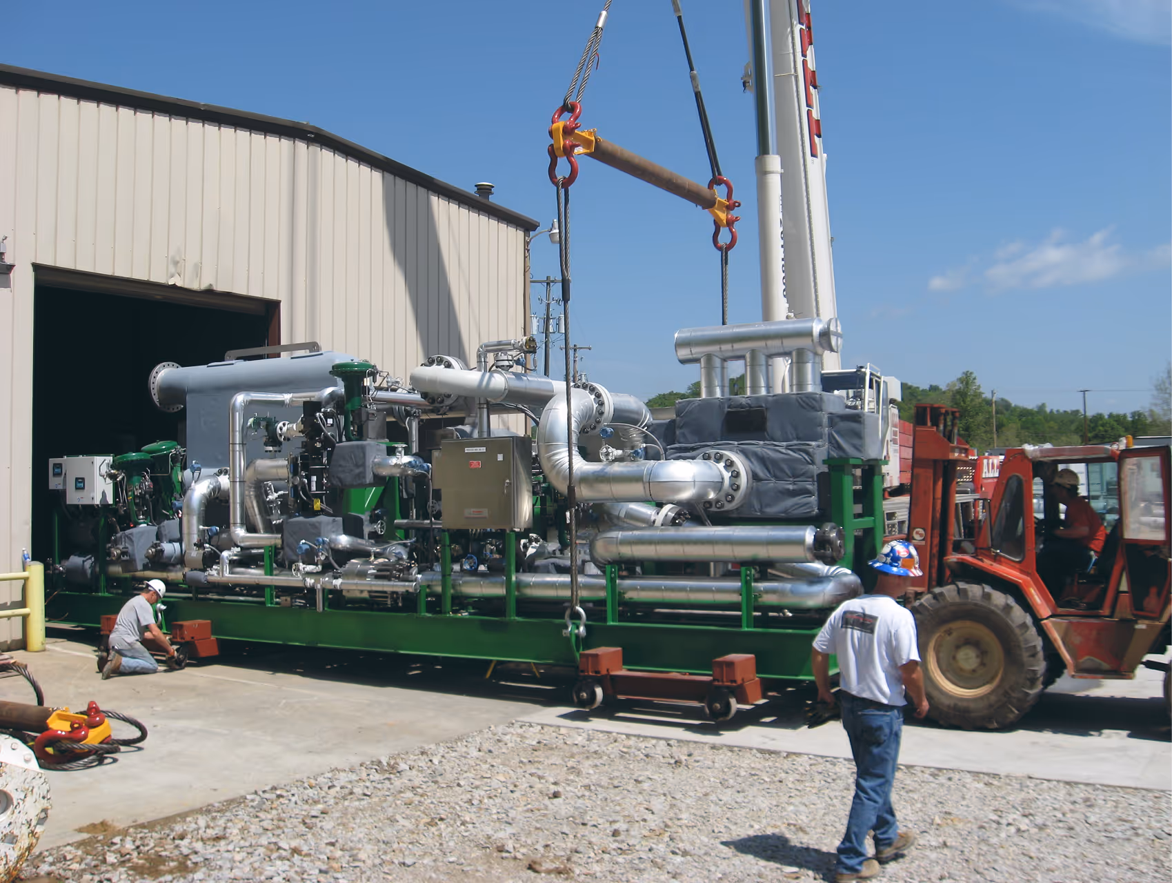 Worker helping load system on rollers