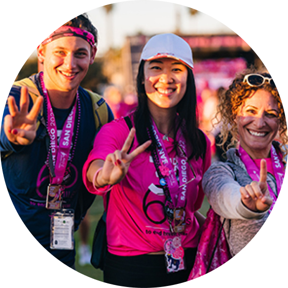 A group of smiling people in pink clothing at a Making Strides for Breast Cancer event. 