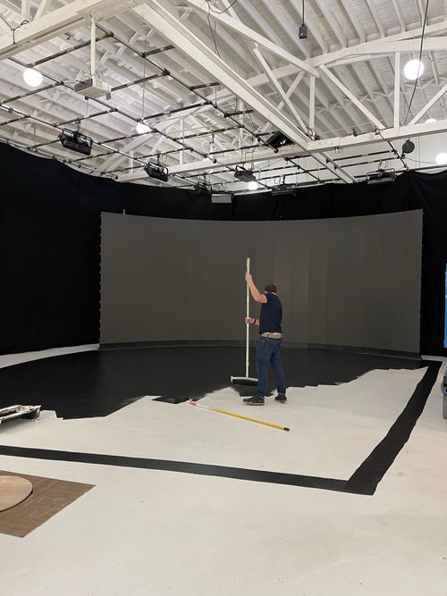 image of workers at machining station (for a manufacturing plant)