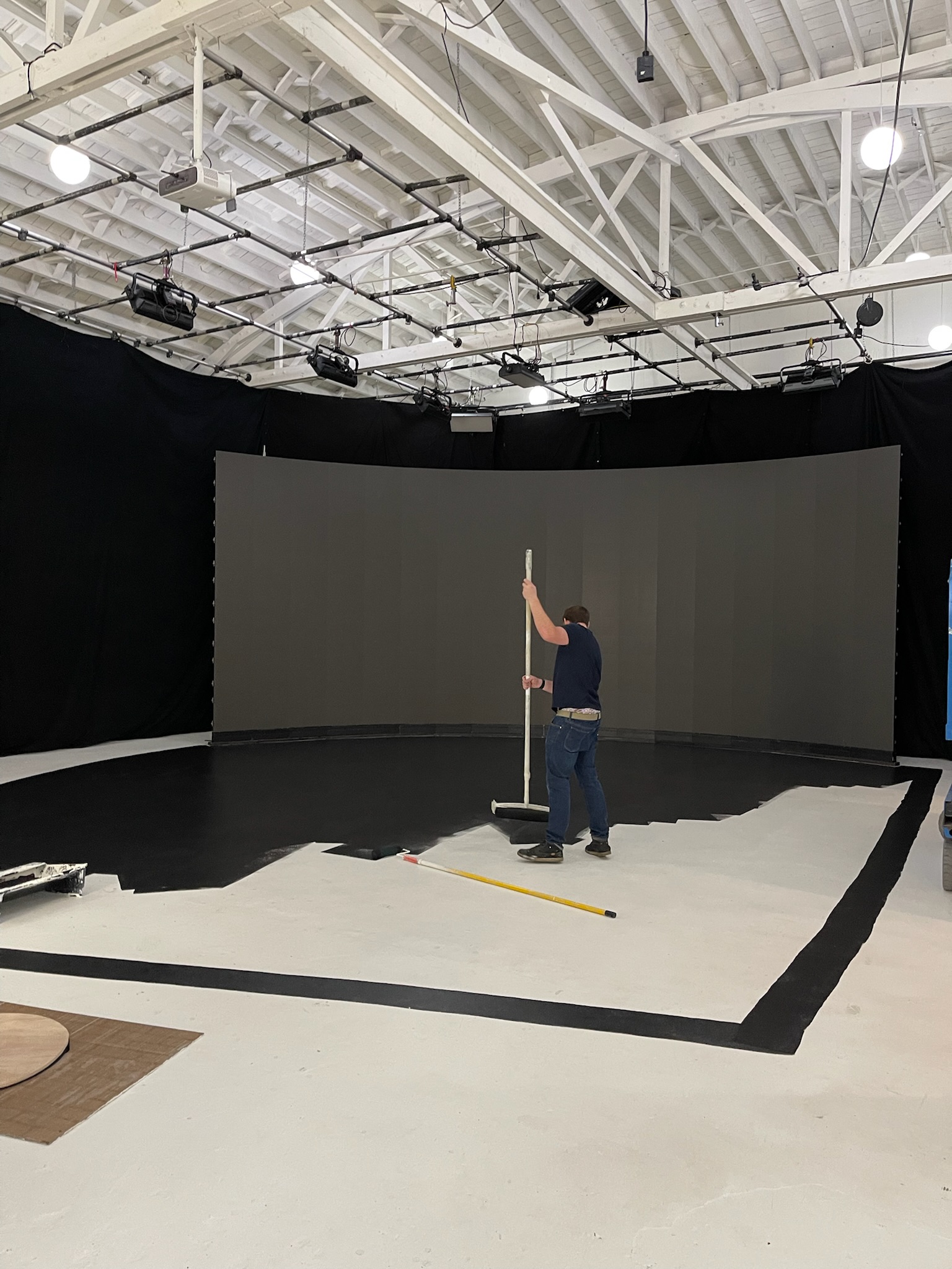 image of workers at machining station (for a manufacturing plant)