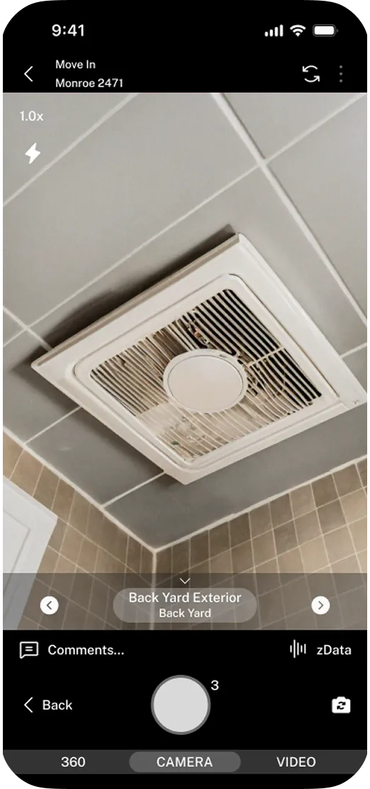 Ceiling-mounted exhaust fan with white grille in tiled room corner.