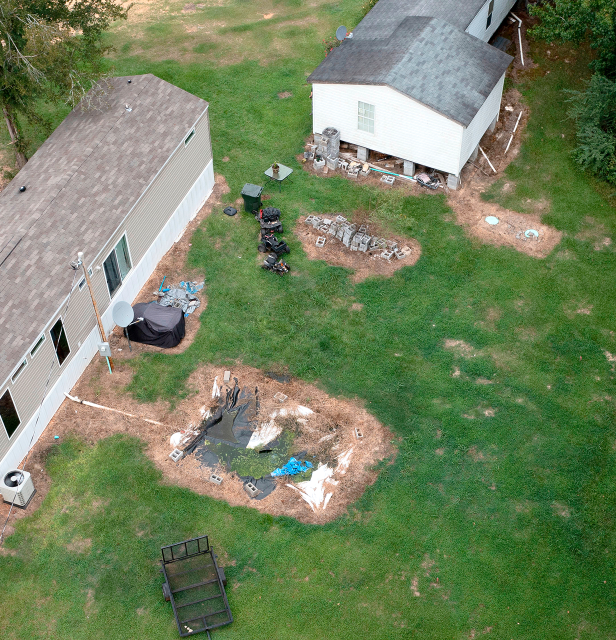 Aerial view of a rural backyard with waste pit.