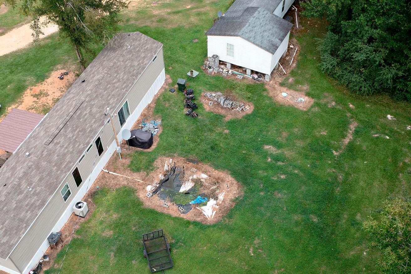 Aerial view of a rural backyard with waste pit.