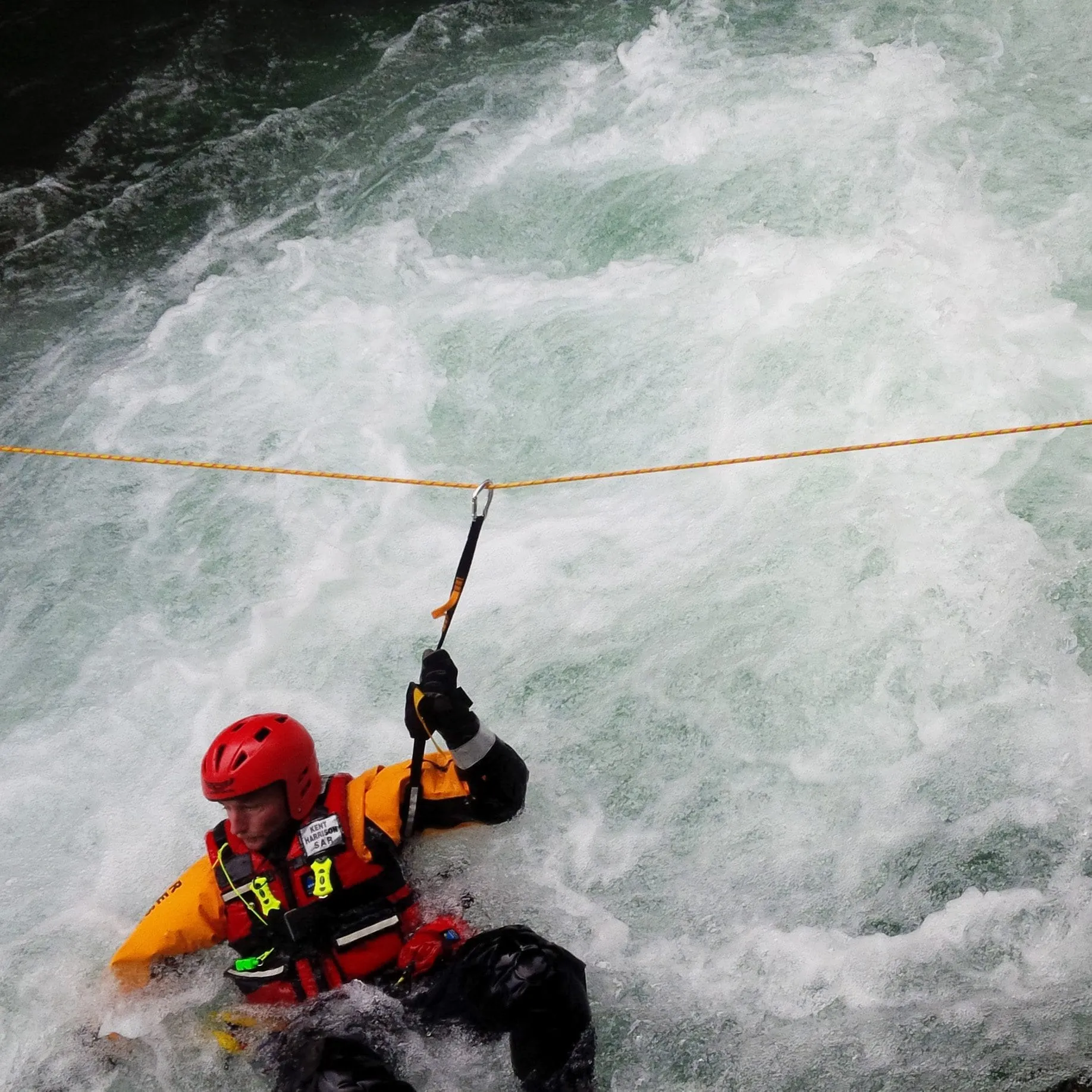 Instructor helping a climber check her harness and rope during rope rescue training