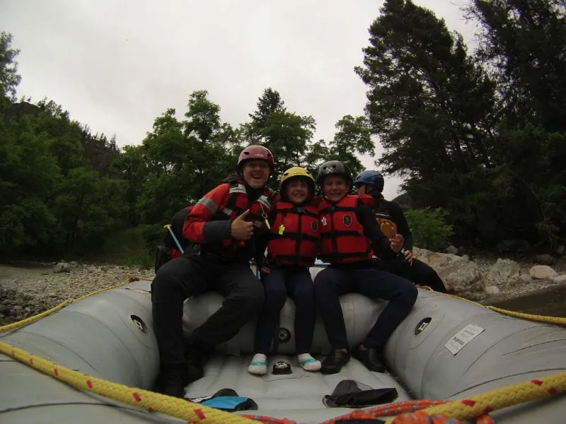Smiling course participant wearing a helmet with a camera during outdoor rescue training