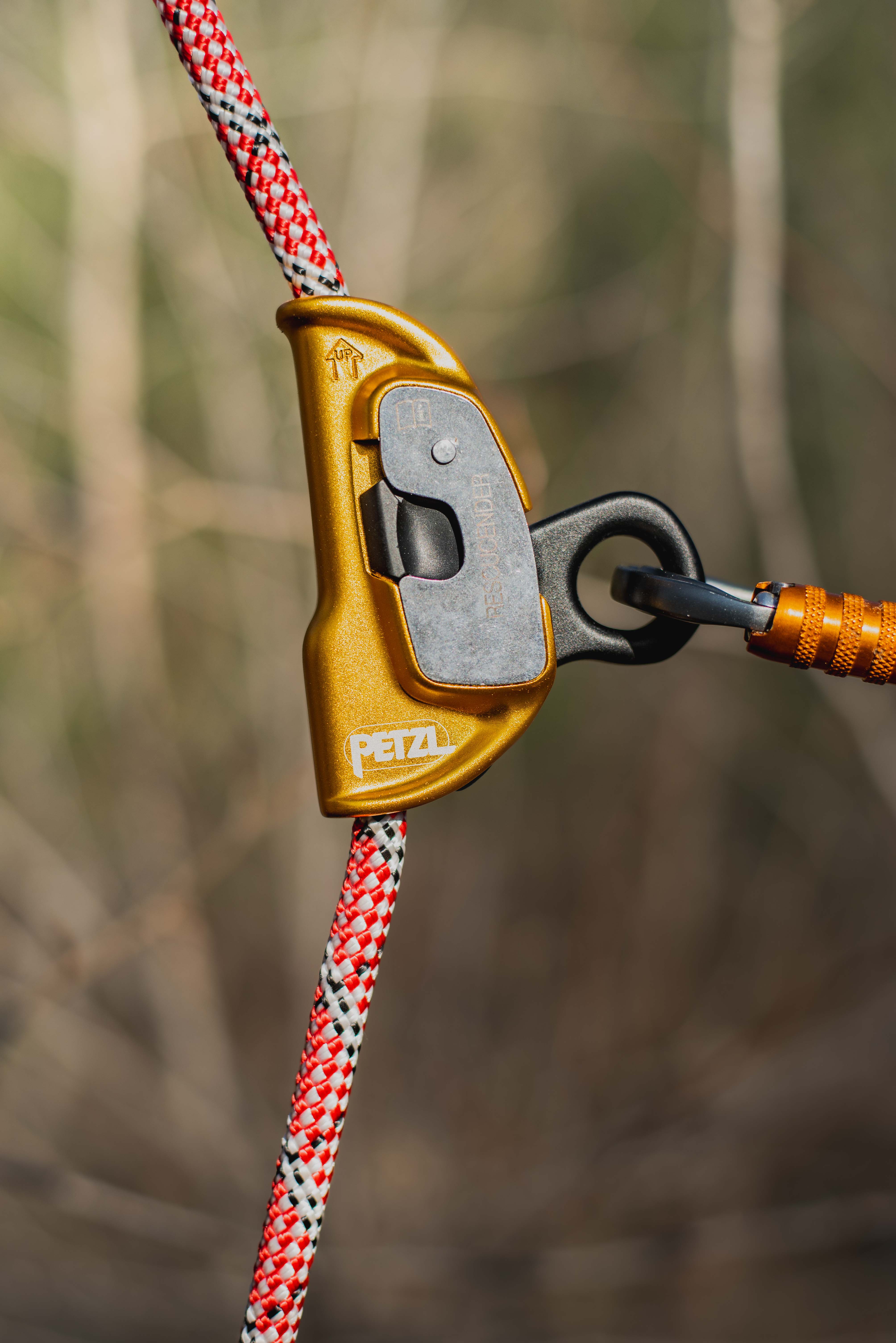 Smiling course participant wearing a helmet with a camera during outdoor rescue training