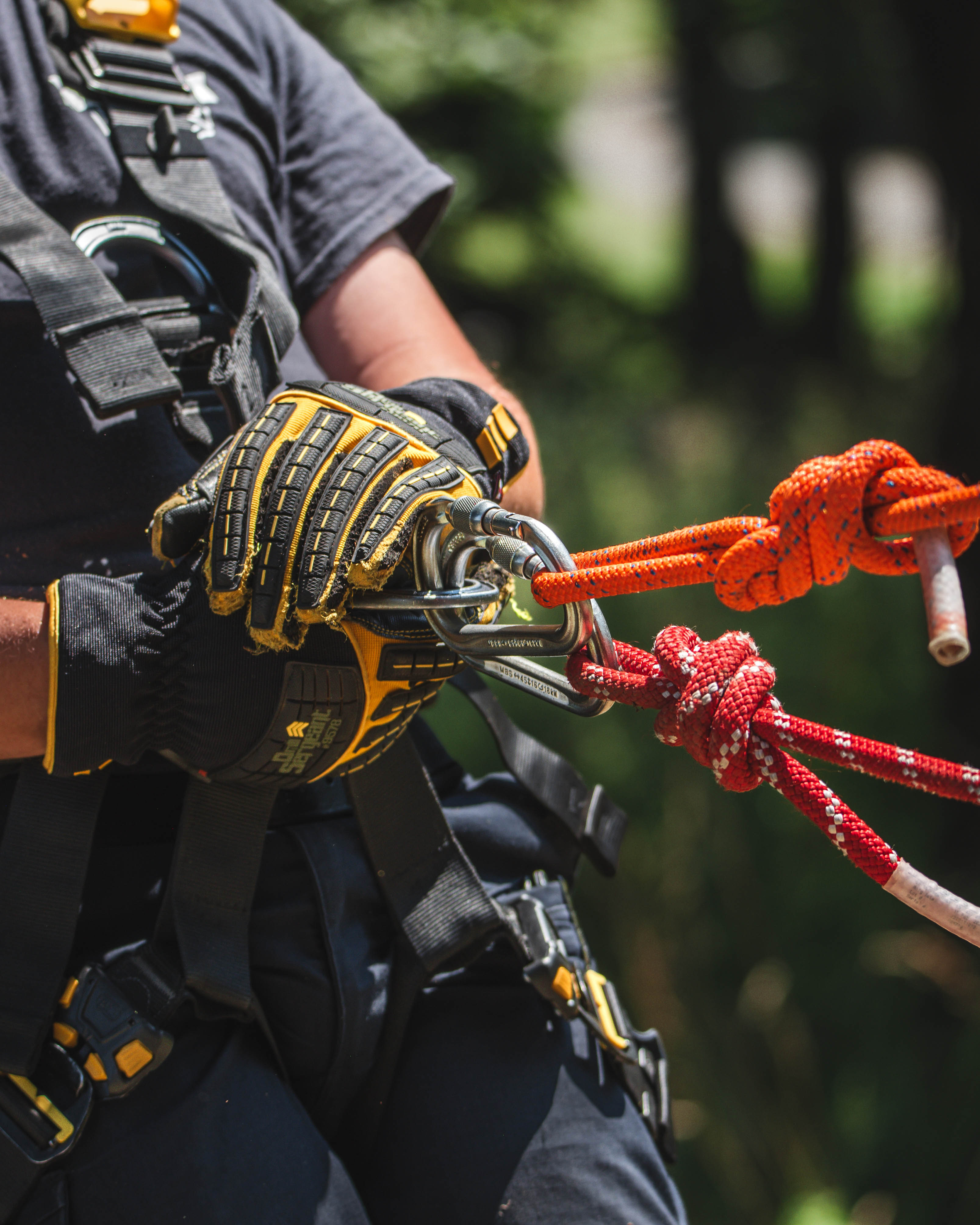 Smiling course participant wearing a helmet with a camera during outdoor rescue training