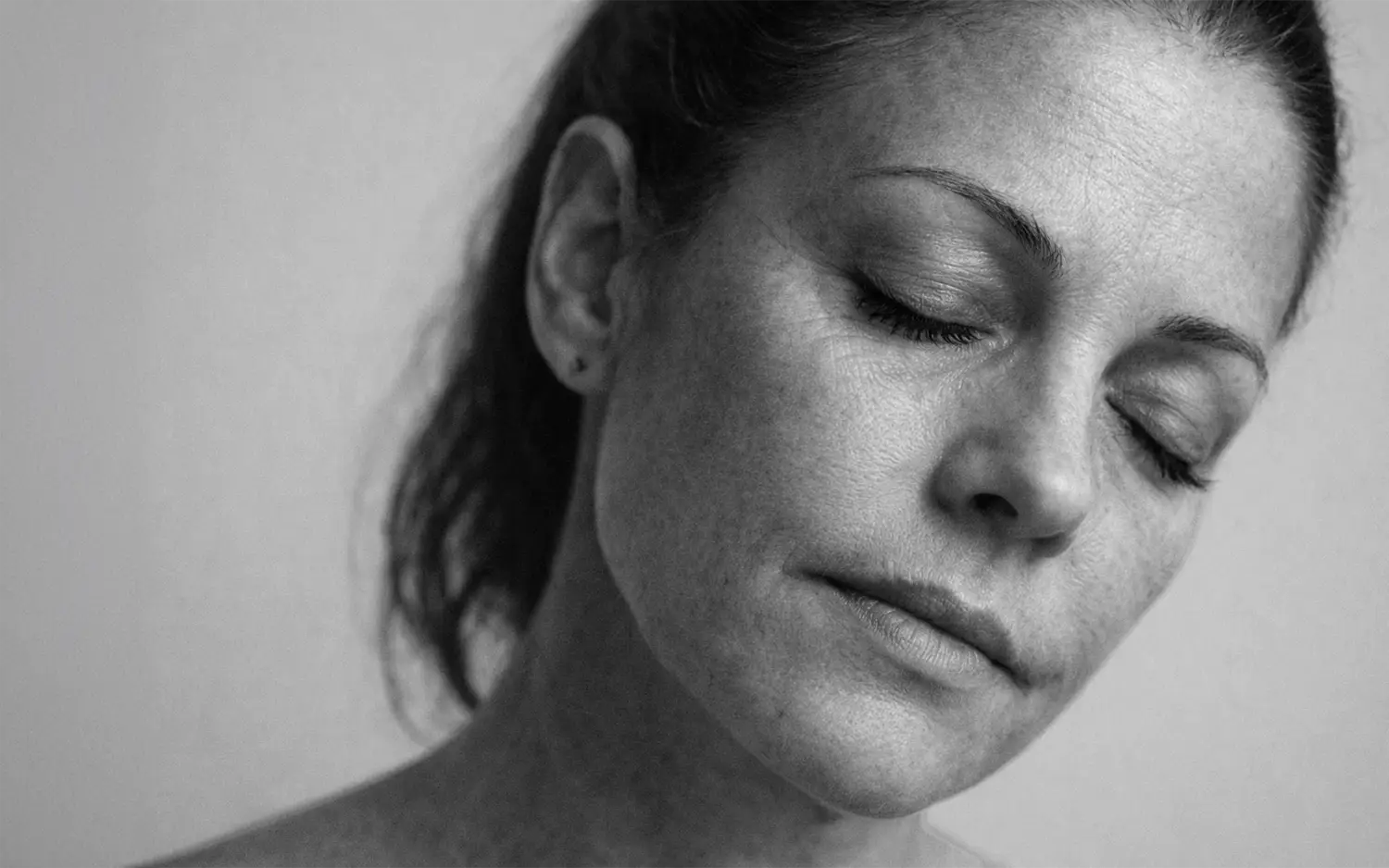 Black and white portrait representing fine lines and wrinkles aging concern at CAMI