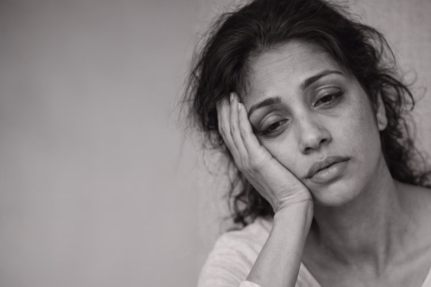 Black and white portrait representing fatigue and low energy as a hormonal wellness concern at CAMI
