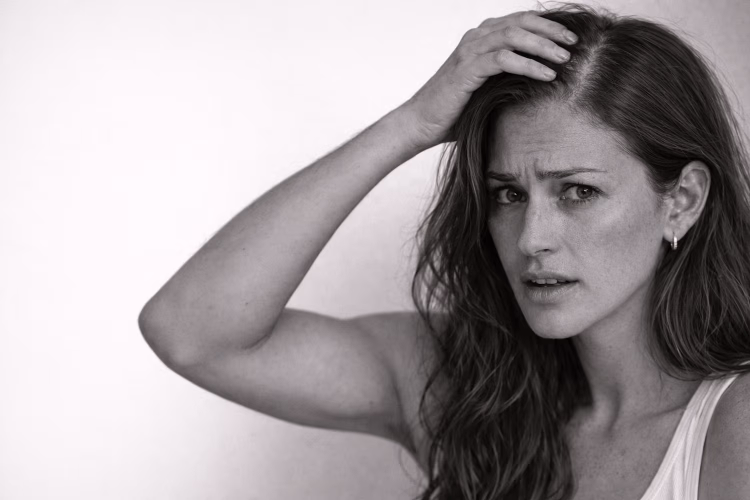 Black and white portrait representing female hair loss and thinning concern at CAMI
