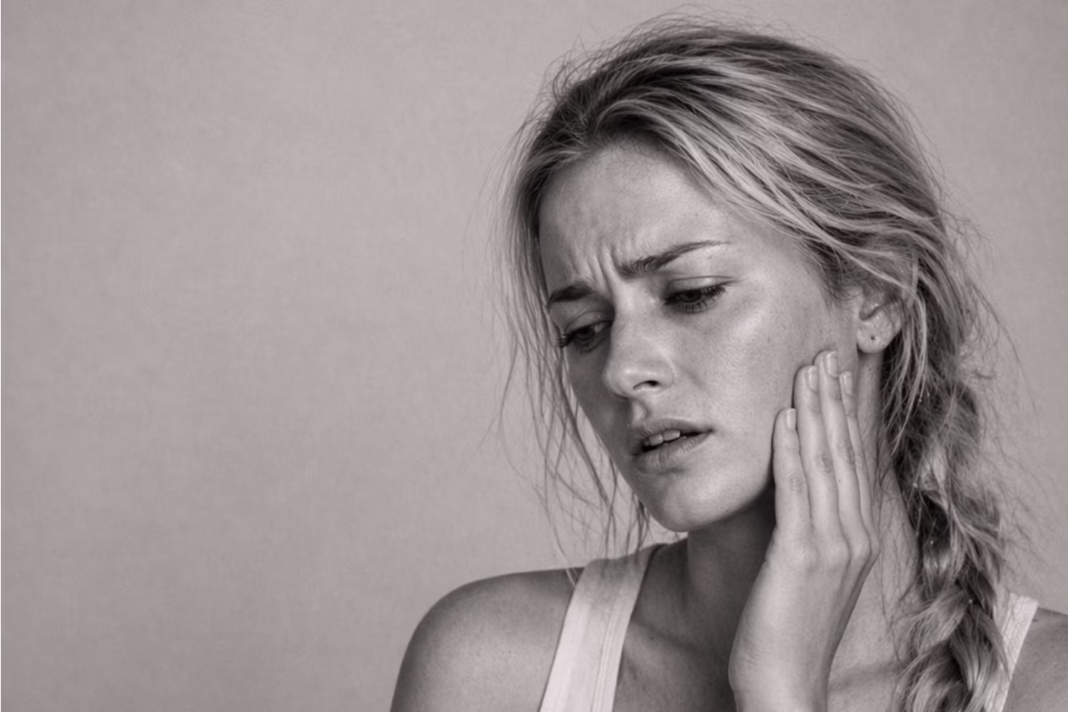 Black and white portrait representing TMJ jaw tension and masseter concern at CAMI