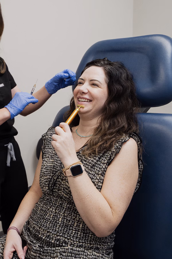 CAMI provider administering dermal filler injection along the smile lines for nasolabial fold treatment
