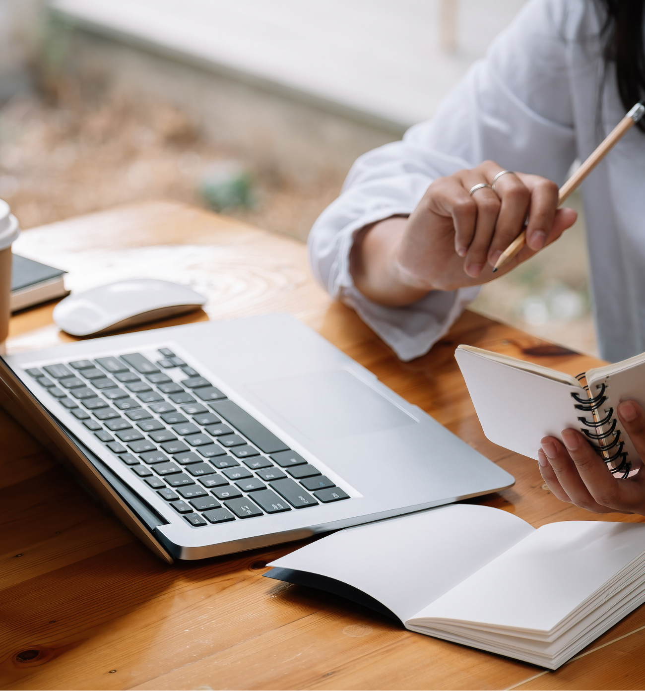 Smiling elderly couple touching foreheads outdoors on a sunny day.