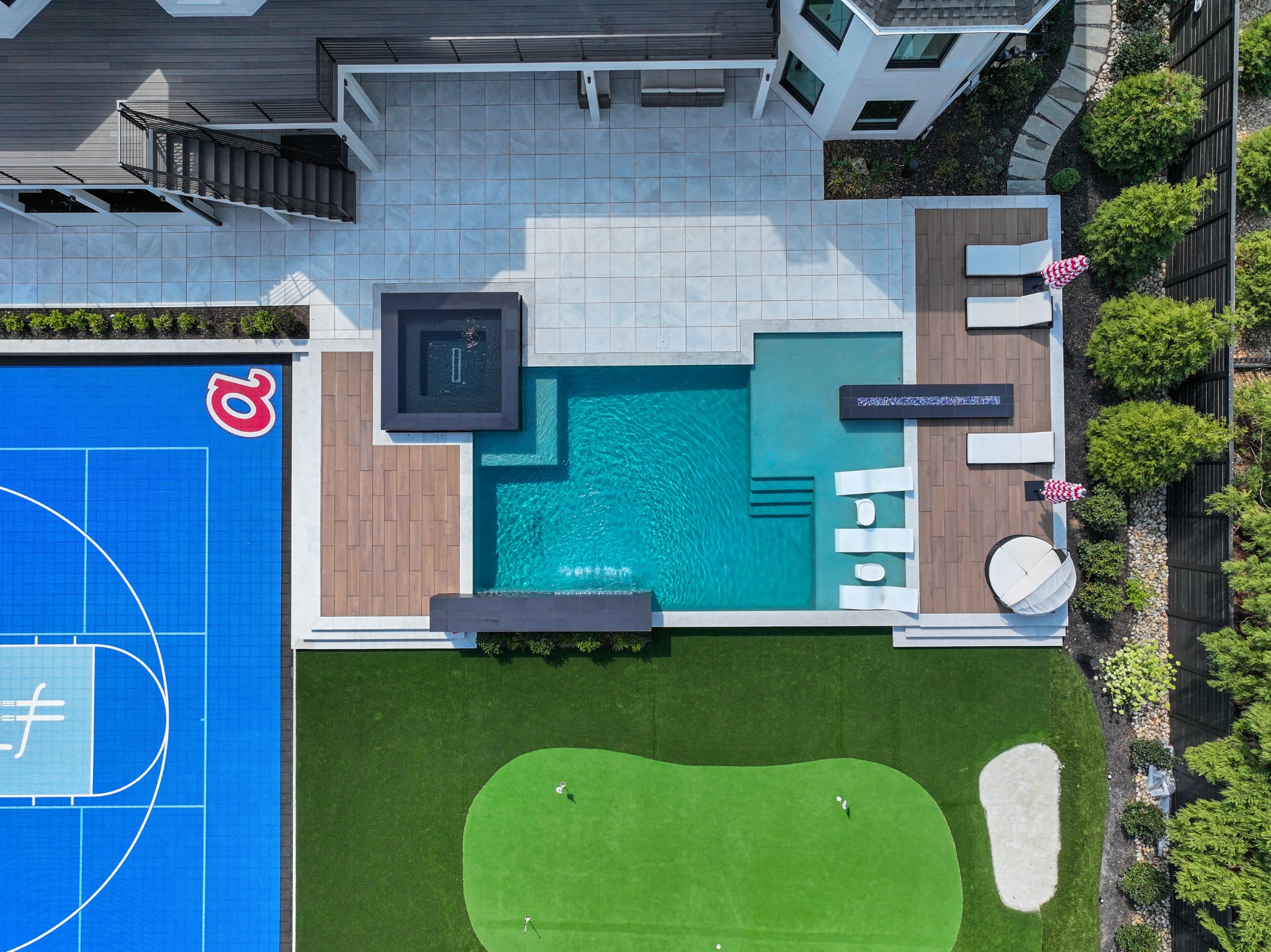 Aerial view of a North Atlanta home with a pool and connected outdoor living spaces