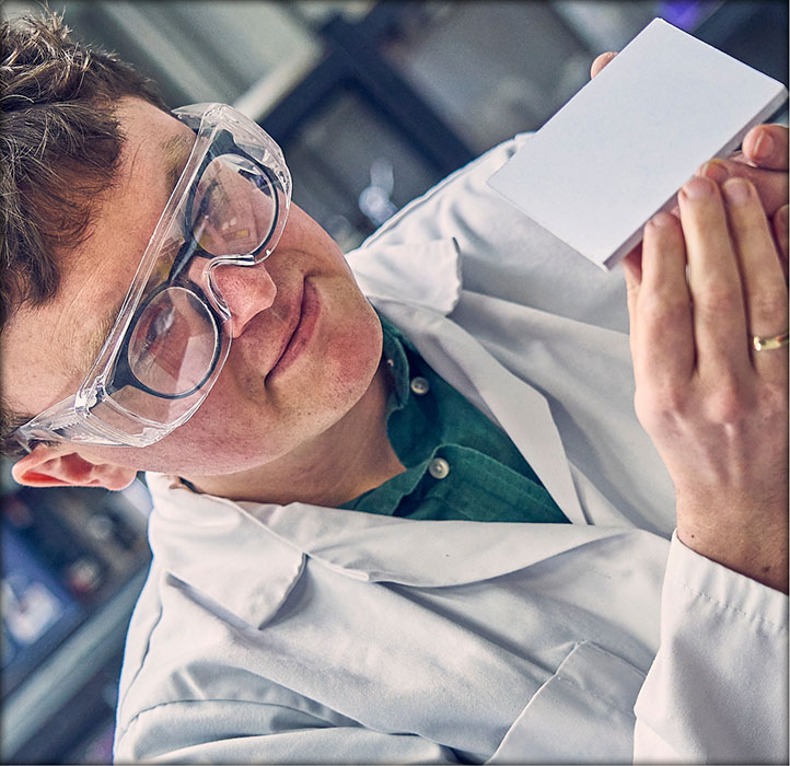 CEO Dr Aled Roberts displaying a white Eralith tile.