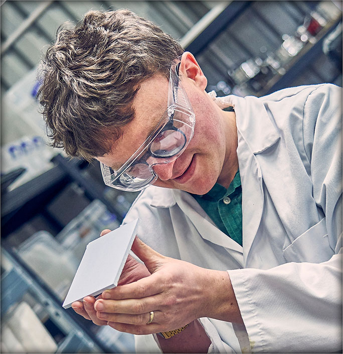 CEO Dr Aled Roberts displaying a white Eralith tile. 