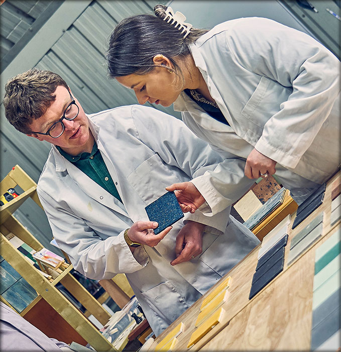 CEO Dr Aled Roberts displaying a blue Eralith tile, in discussion with a Dekiln team member.