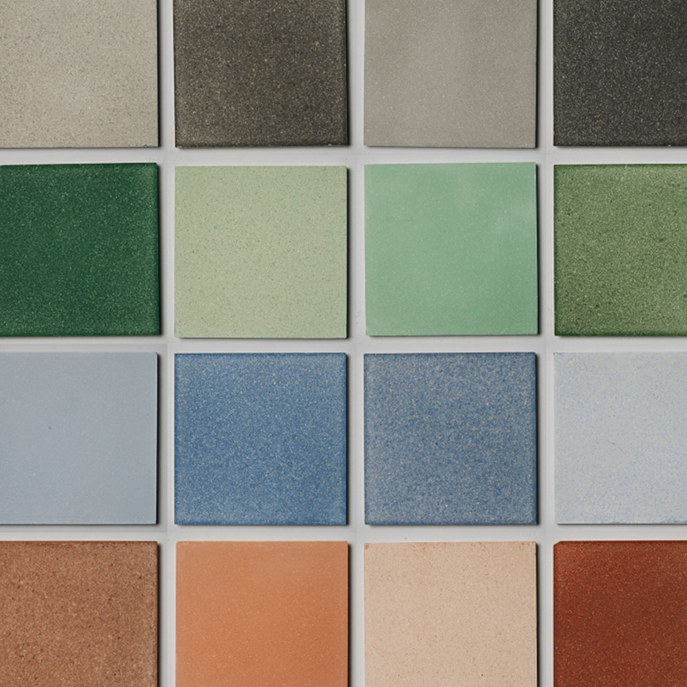 A grid of Dekiln's sustainable Eralith tiles, in colours including grey, green, blue, red, and orange.