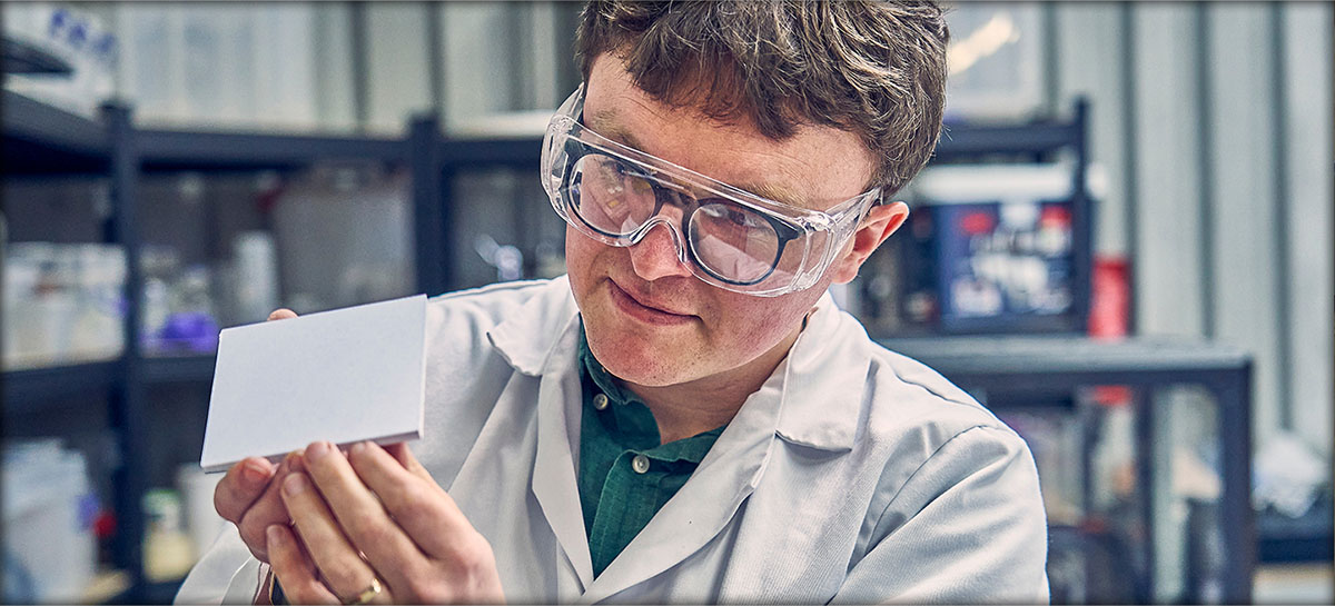 Dr Aled Roberts, Dekiln CEO, assessing a white Eralith sustainable tile. 