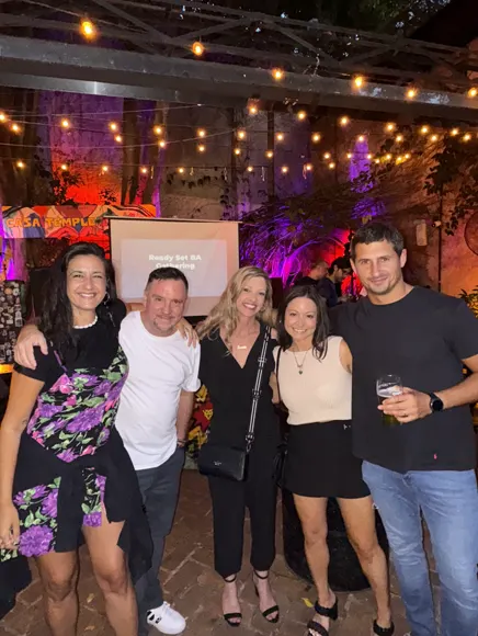 Five teammates at an evening team party